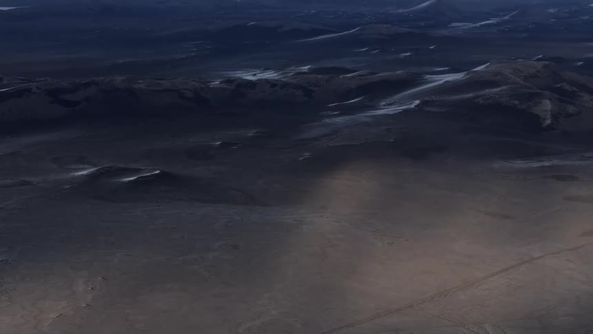 Aerial of mountainous desert during sunset