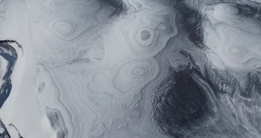 Aerial above a frozen black and white desert