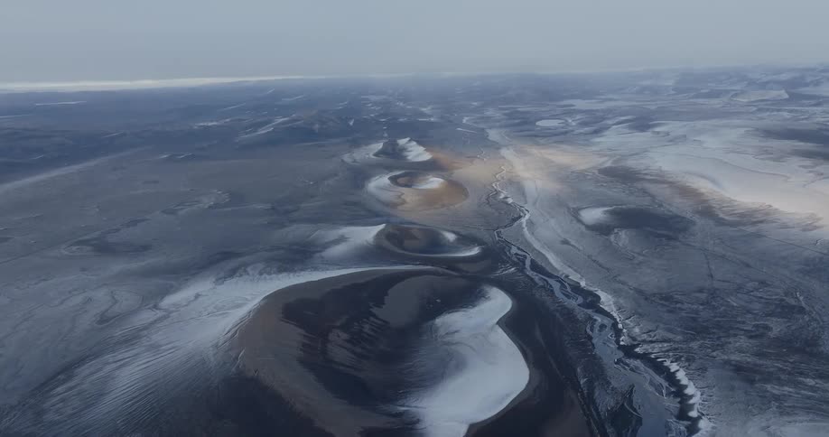 Craters in a black sand desert