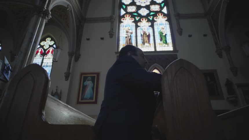 A man is praying in the church