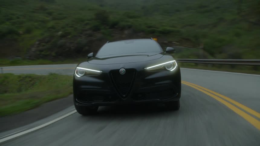 Luxury car drives on a mountain pass