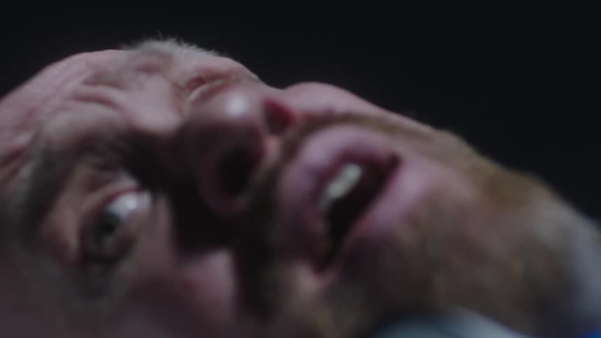 A man lying down very scared