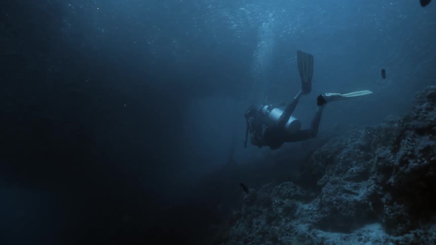 Scuba diver swimming near the ocean floor