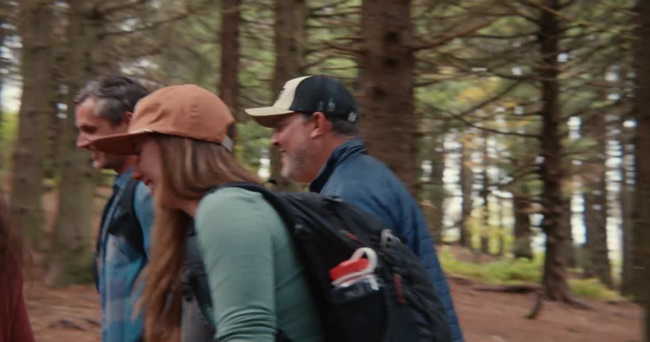 A group of people walking through the forest