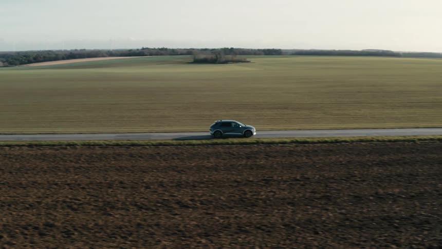 A car driving on a deserted road in the countryside