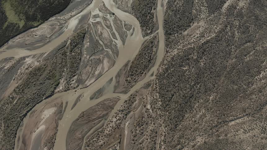 Aerial of the river with dark water on the plain with undergrowth during the day