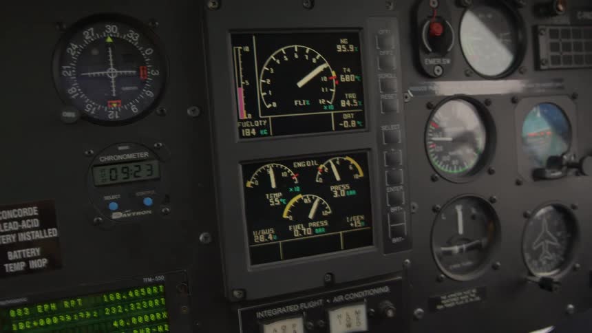 Analog and digital flight instruments display aircraft information in cockpit dashboard
