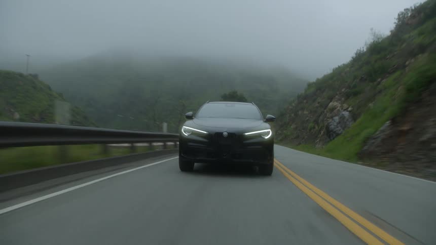 A car driving at high speed on a mountain road