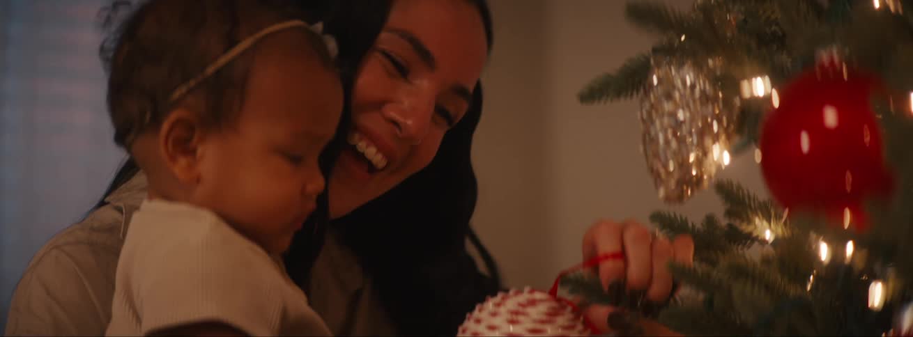 Mother and daughter with christmas decorations in their hands