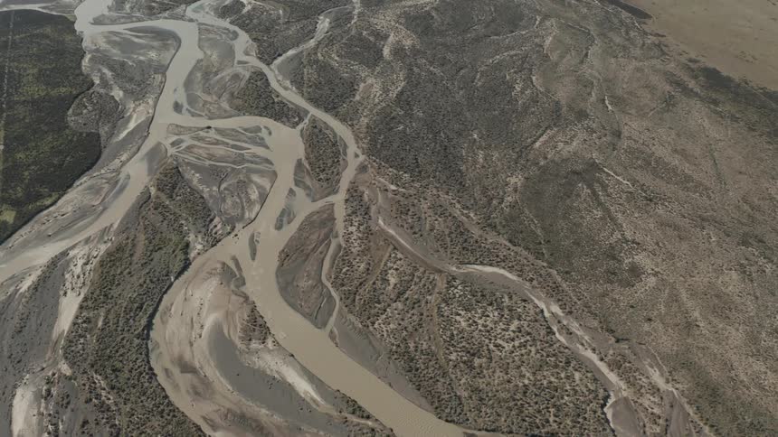A river with brown water and mud in the nearby lands