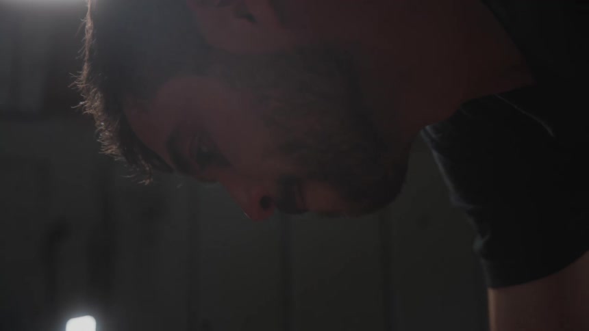 Portrait of a bearded man looking downward