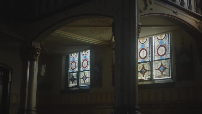 The sun is shining through the stained glass in the church