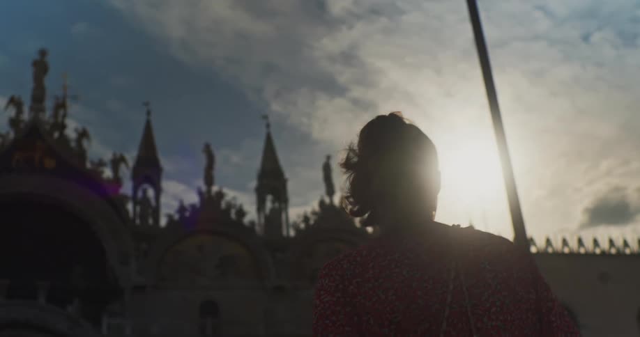 A woman is touring the front of a castle