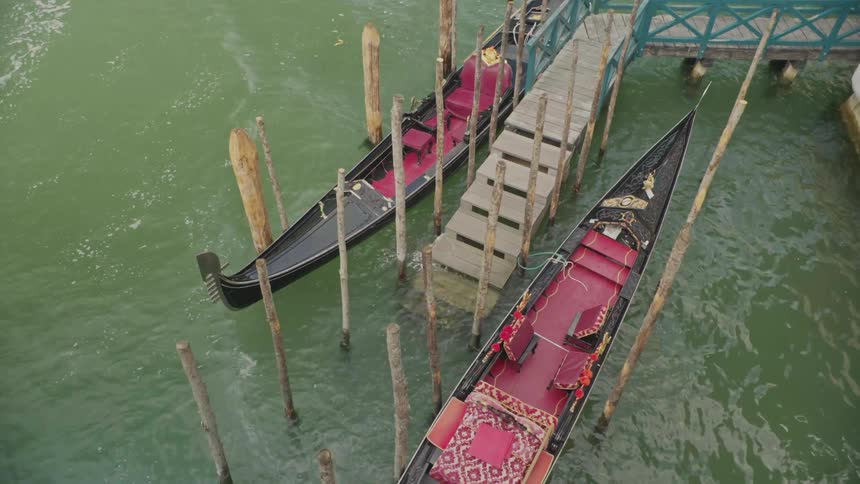 A couple of gondolas on a pier in venice