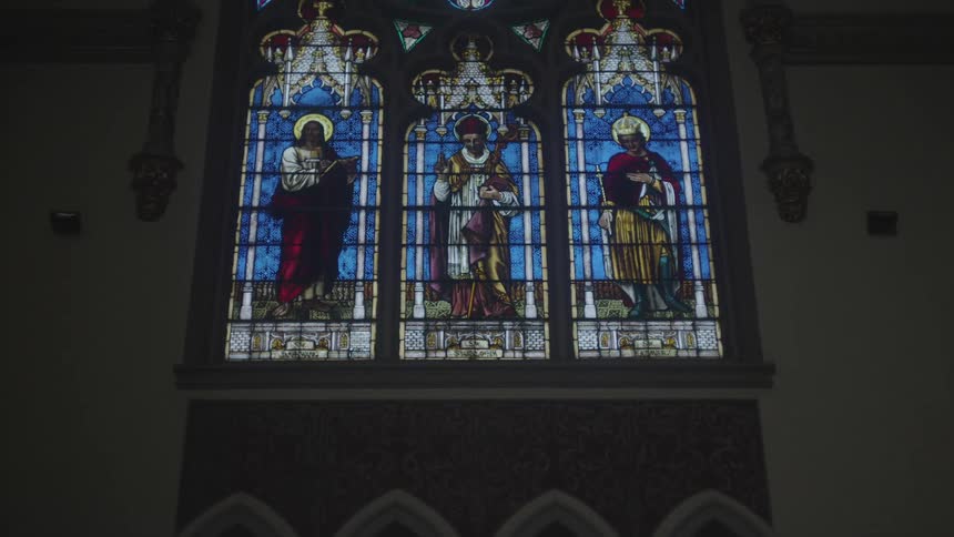 Light shines through the stained glass windows in the church