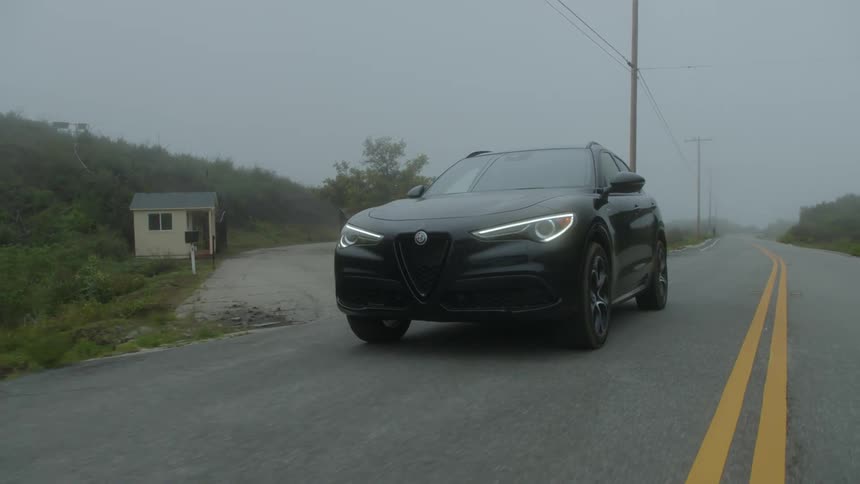 A black car speeding on the desert road