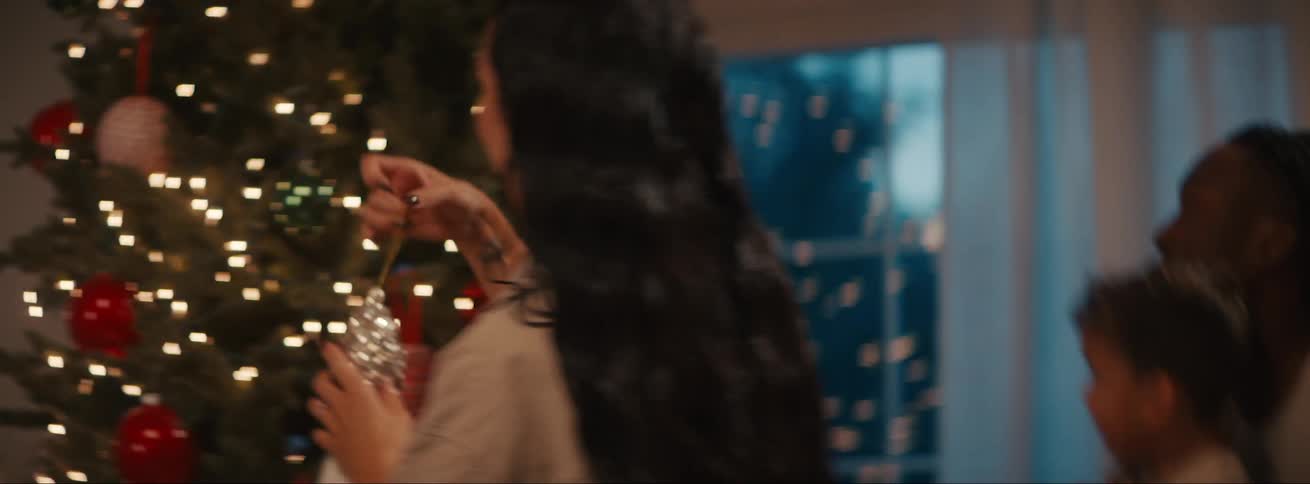 A family decorating a christmas tree
