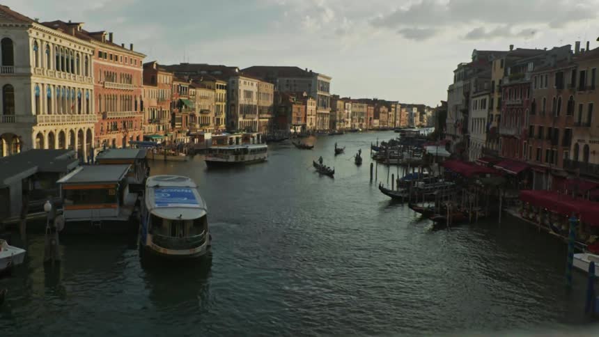 Boat on a river with buildings on both sides