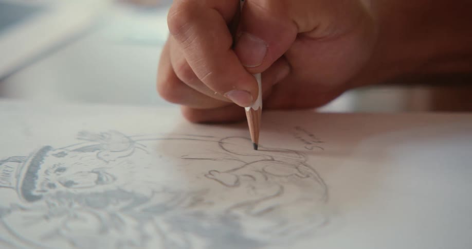 A clip of a person sketching on the paper