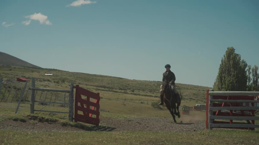 A man speeding on horseback heading to the ranch