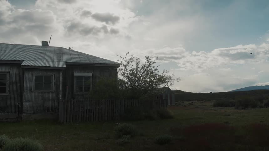 The exterior of a house in a rural area at dawn