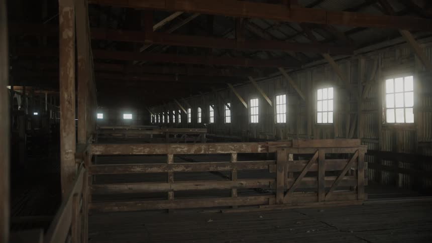 An empty barn with wooden partitions