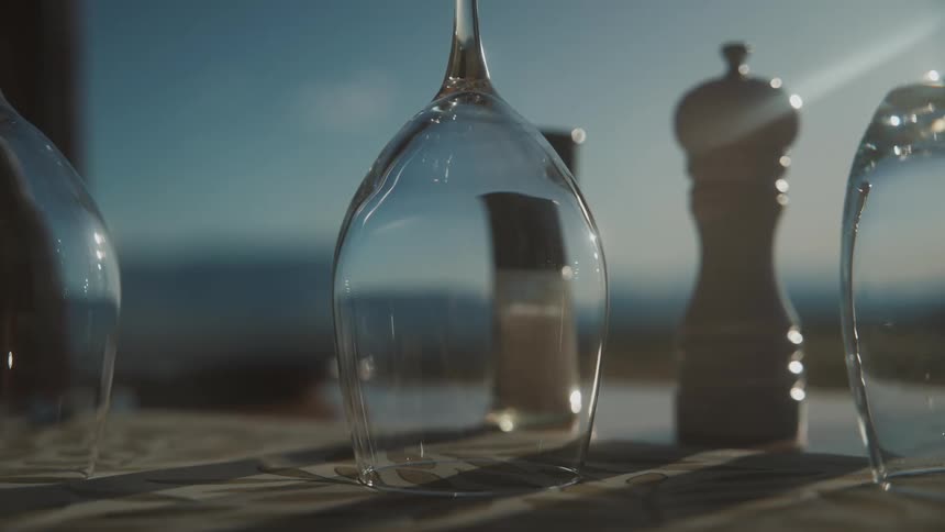 Reflection of salt and pepper shakers on upside down stemware