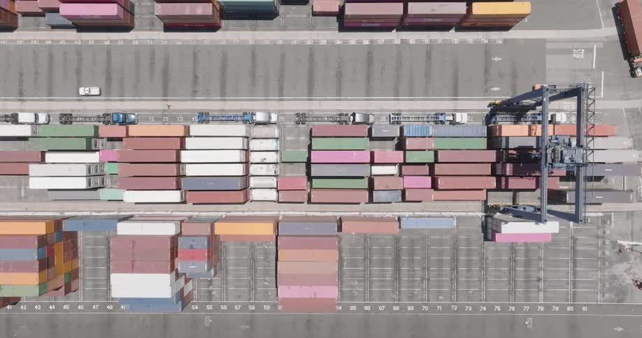Aerial panorama of a logistics center with containers and trucks traveling