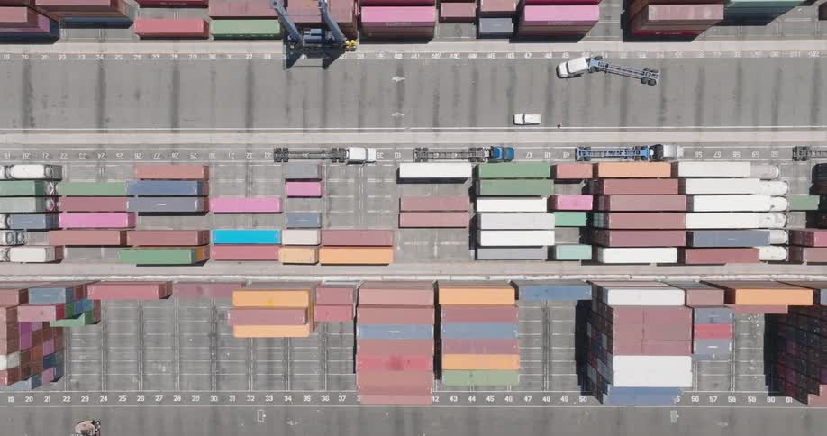 Aerial view of trucks driving around a container yard