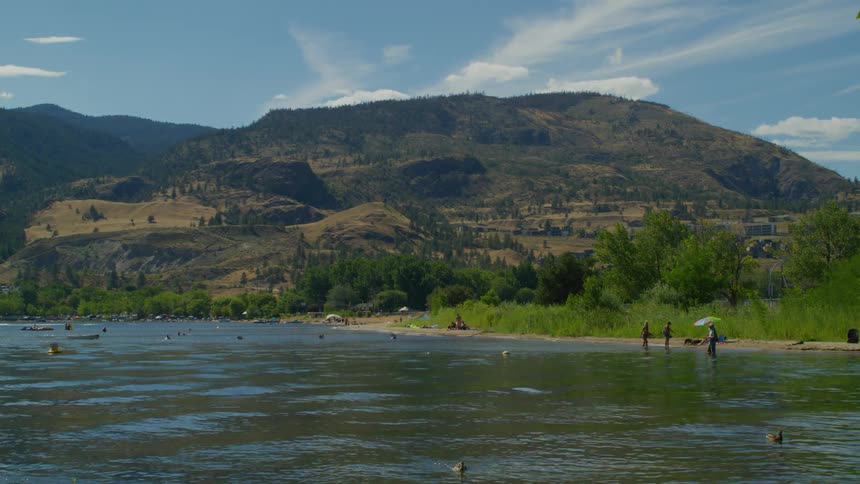 People bathe in the waters of a river in summer