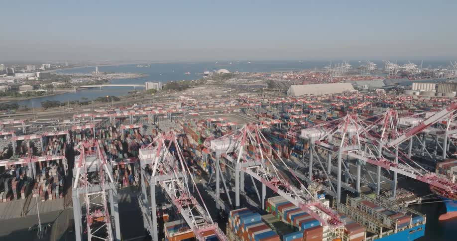 Cranes are placing containers on top of a huge docked ship