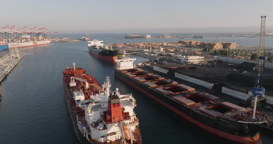 Cargo ships and marina in motion at the port in the morning