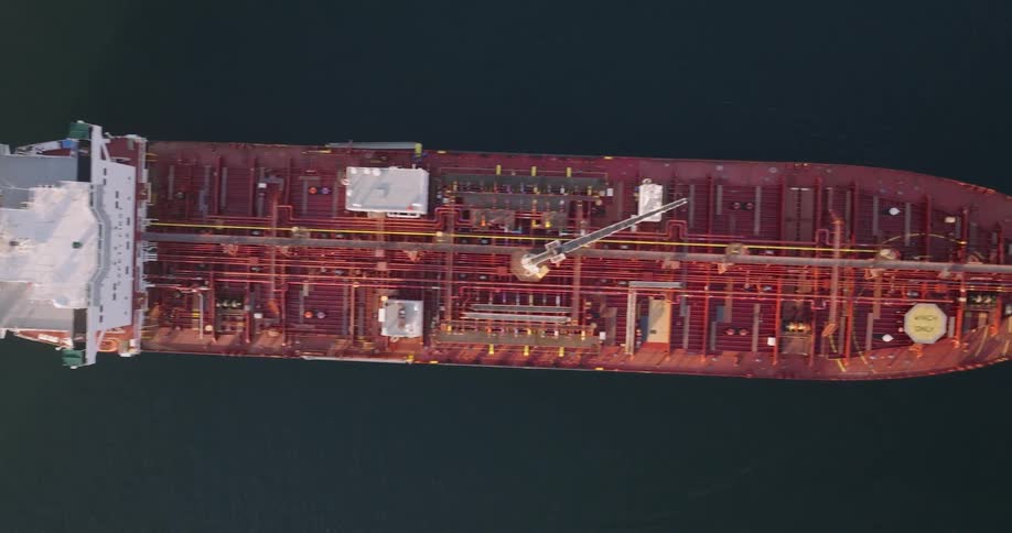 Aerial of two boats tied to a vessel ship on the sea at midday