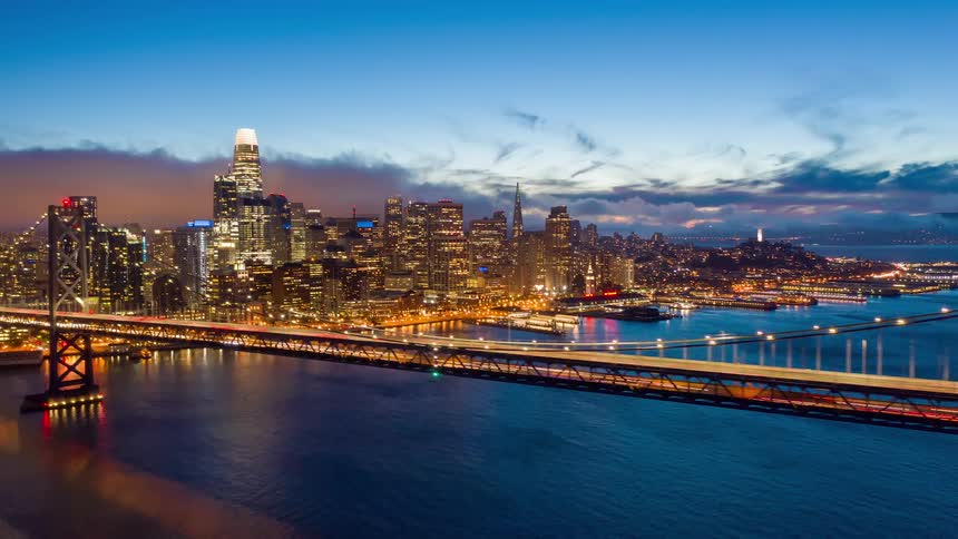 A busy city view with a long bridge on fast time lapse