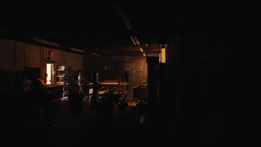 Man walks in a dark room