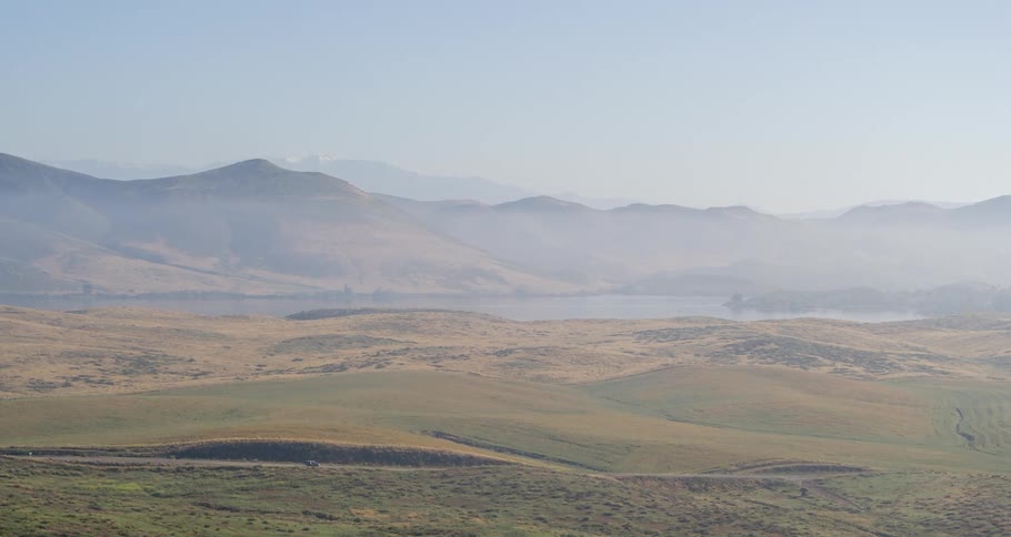 Aerial of countryside with mountains and busy highways during the daytime