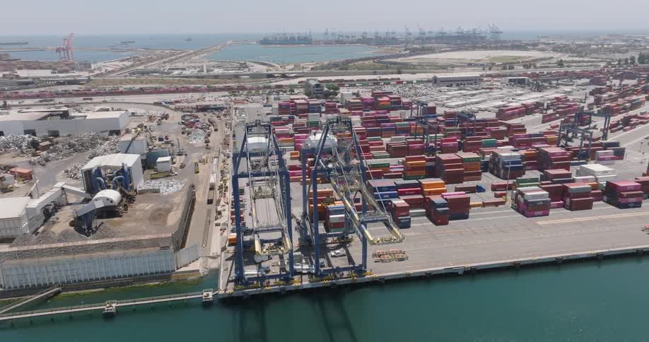 A huge container crane and several of them behind in a ship loading area