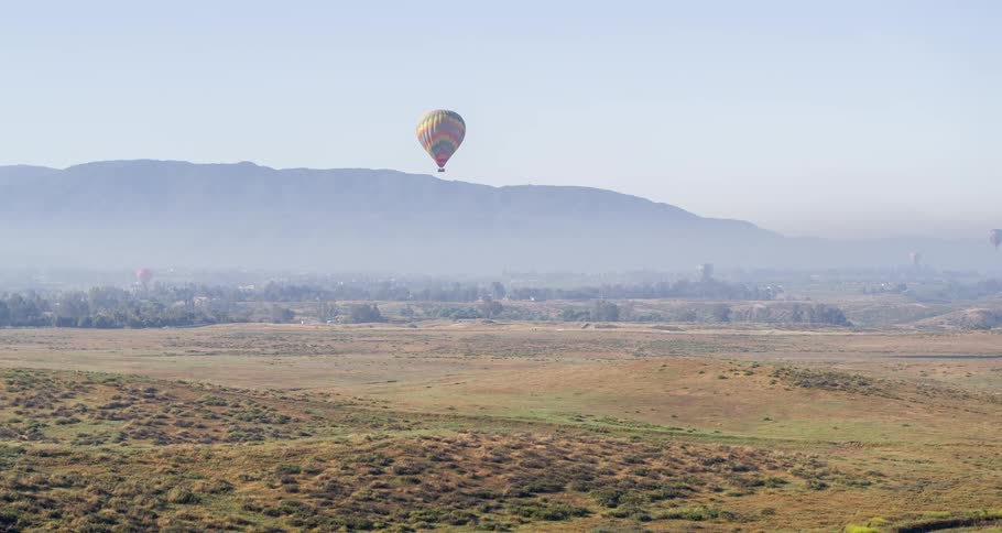 Aerial view of hot air balloons flying over the countryside