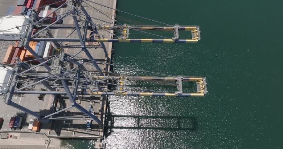 Aerial panorama of a logistics port with shipping containers by the seaside