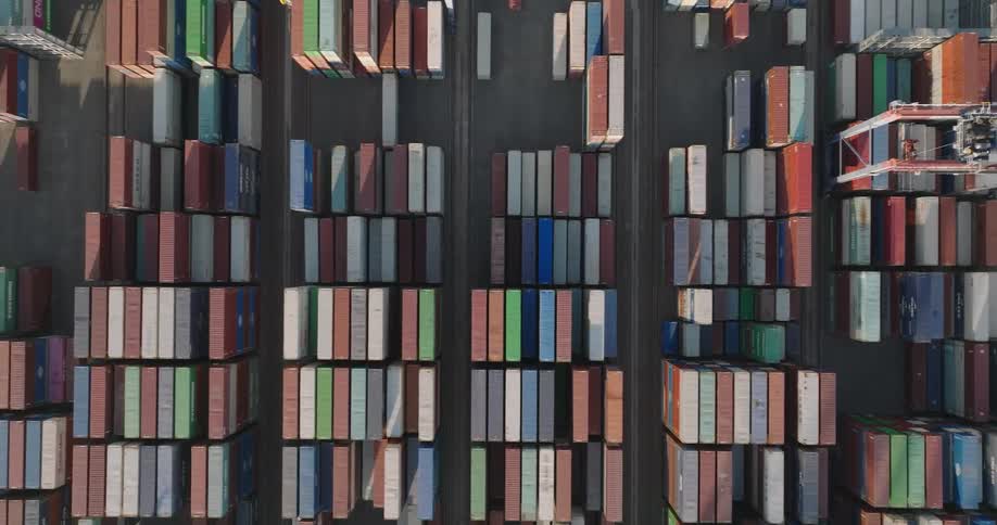 A place full of stationary containers and moving cranes