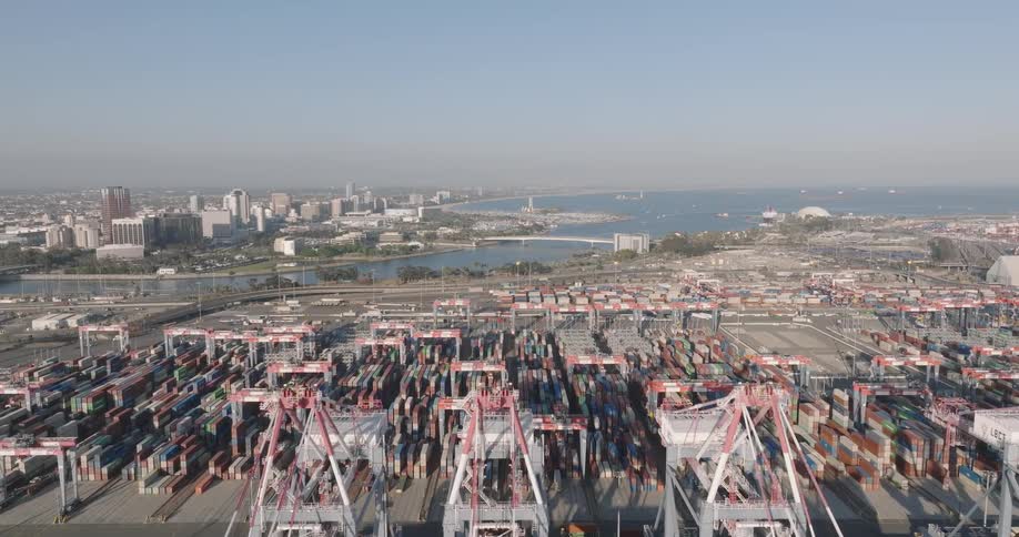 An aerial view of an industrial shipyard on the waterfront of a city