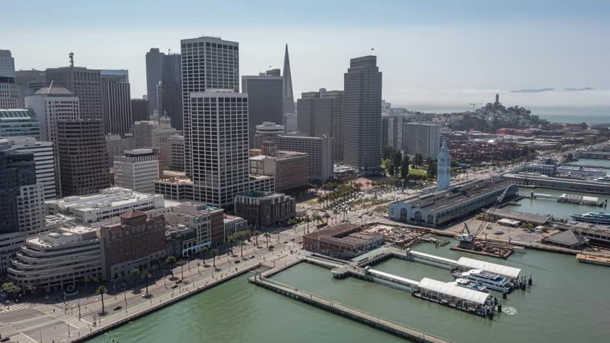 An iconic aerial view of the san francisco ferry building with the city skyline in the background showcasing the citys beauty and grandeur