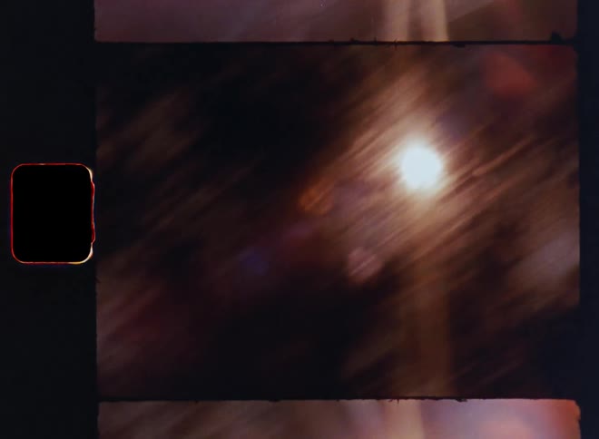 Dynamic endless loop of blinding sun light shining down and racing between the greenery and trees of a forest during a road or train trip on a sunny summer day causing bright lens flares and glares in the genuine vintage super 8 film camera