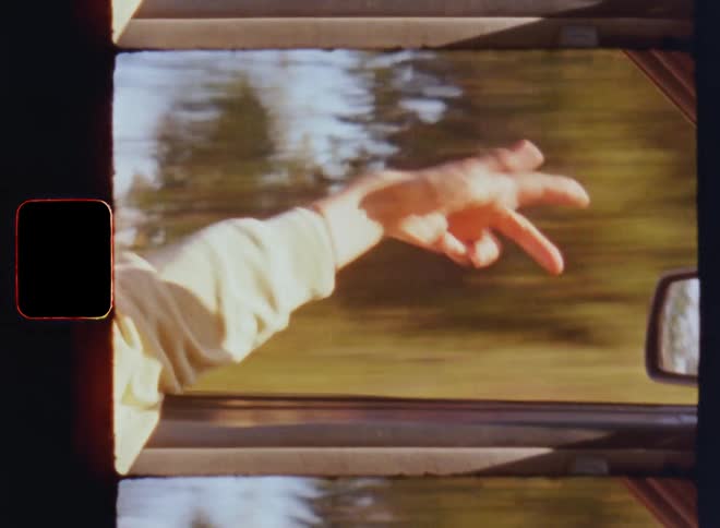 Cheerful hipster person holds or stretches his arm out of the open window of a speeding car while moving his hand freely enjoying the wind speed or tempo and fresh airflow as symbol for good vibes high spirits and happy mood with positive energy