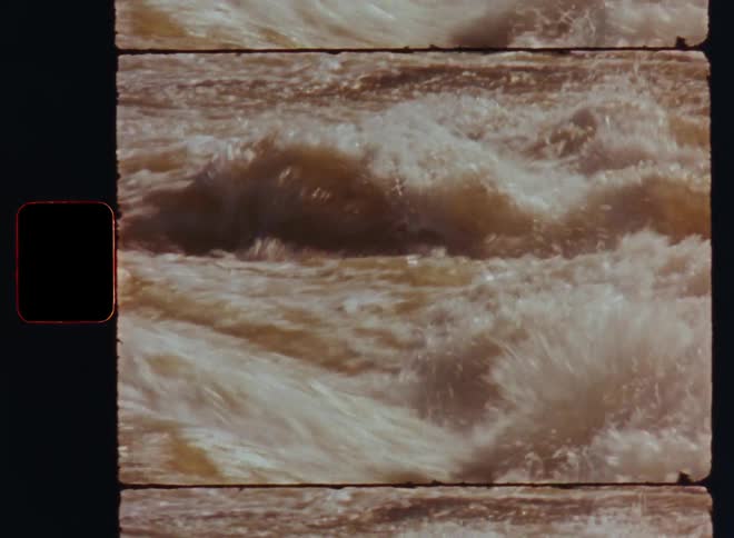 Rapidly flowing water moves turbulently through a rocky riverbed