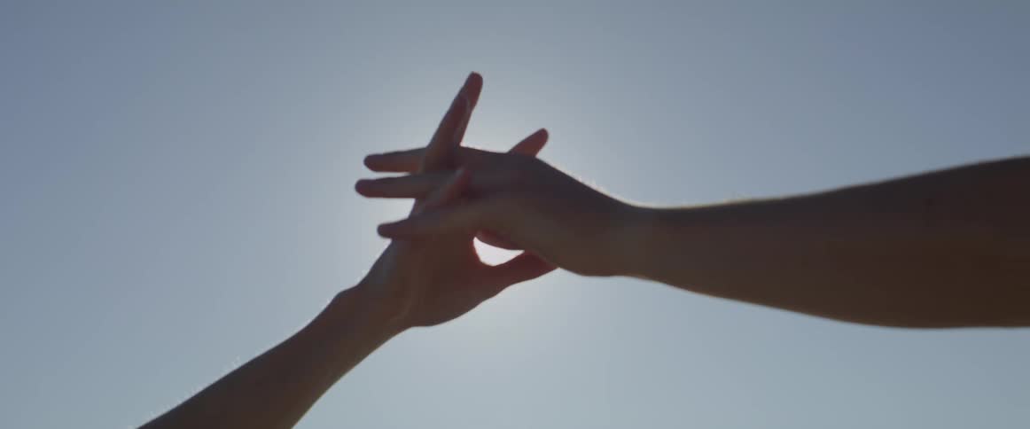 A clip of two hands shaking under the sunlight