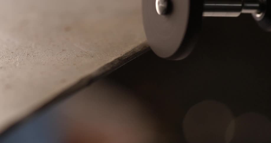 A person is using a grinder to smooth out an edge