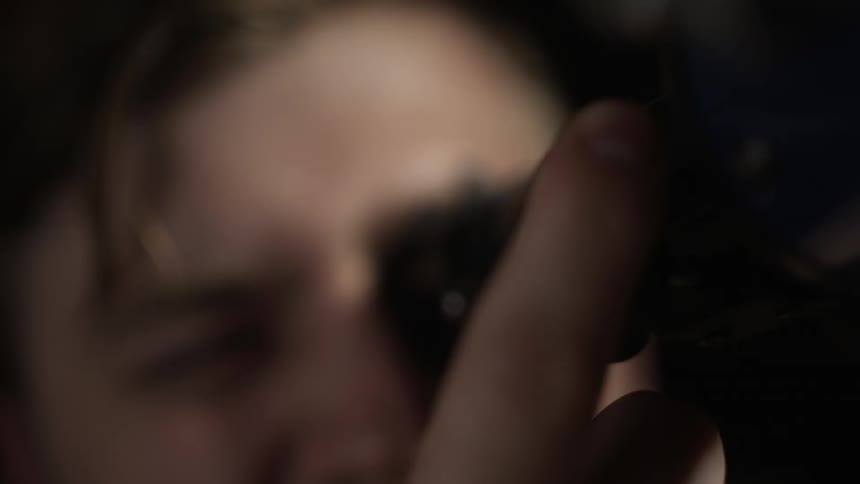 A man is turning the knob on a telescope