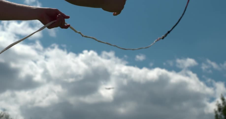 A person throws a rope with a handle into the air