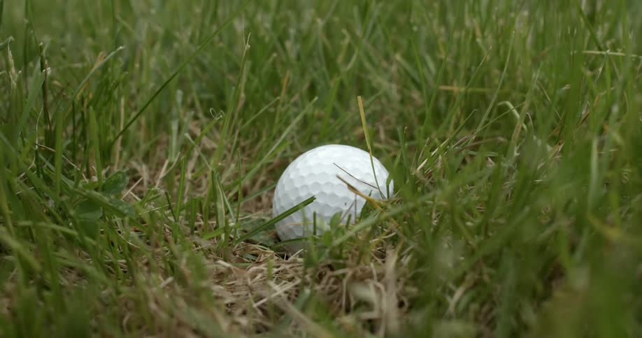 A golf ball is struck off the grass
